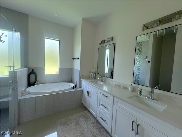 bathroom featuring vanity, plus walk in shower, and tile patterned floors