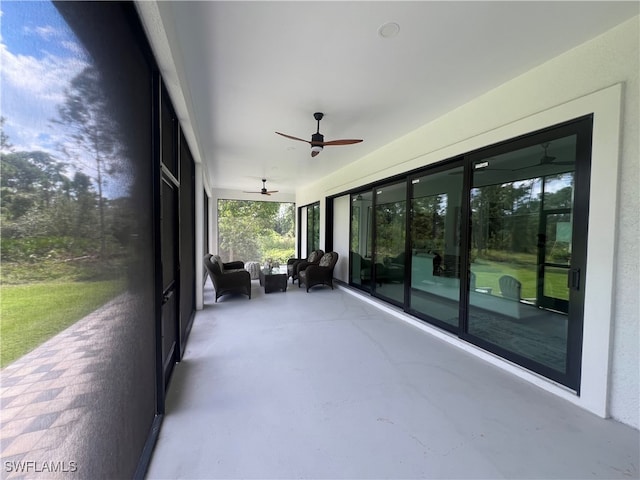 unfurnished sunroom featuring ceiling fan