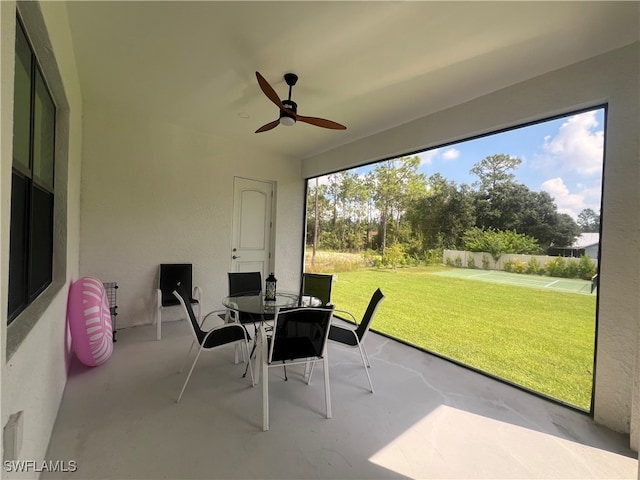 sunroom featuring a healthy amount of sunlight and ceiling fan