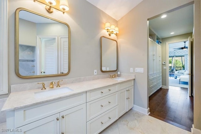 bathroom with vanity, hardwood / wood-style flooring, and ceiling fan