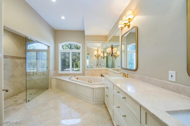 bathroom with vanity, an inviting chandelier, and independent shower and bath