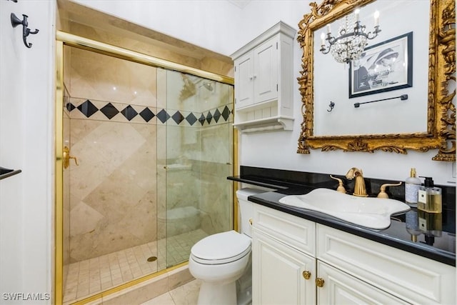 bathroom featuring tile patterned flooring, vanity, toilet, and a shower with shower door