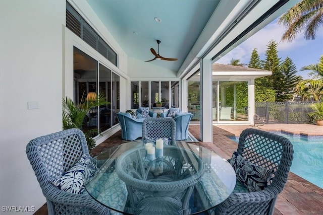 sunroom / solarium featuring ceiling fan and vaulted ceiling