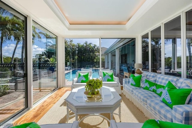 sunroom / solarium with a raised ceiling