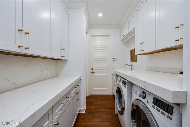 laundry room with cabinets, independent washer and dryer, dark hardwood / wood-style flooring, and ornamental molding