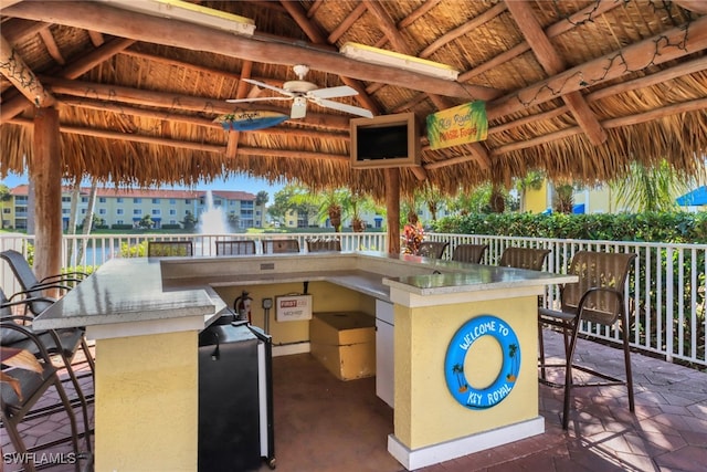 view of patio with a gazebo, an outdoor bar, and ceiling fan