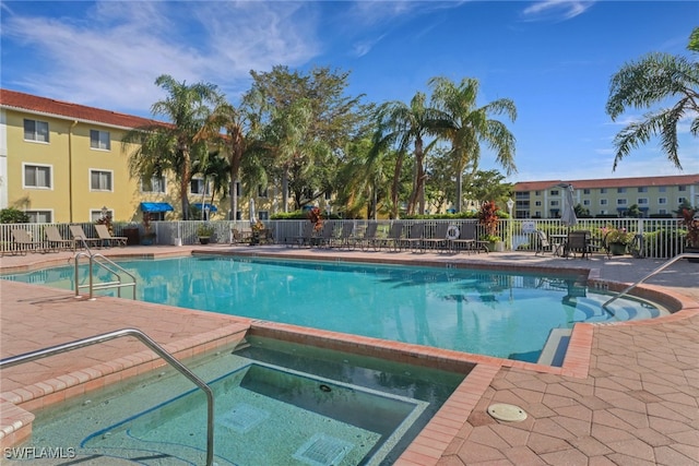 view of swimming pool featuring a patio and a community hot tub