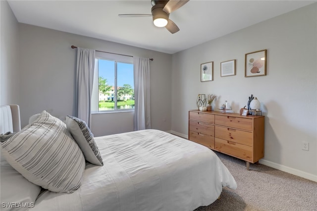 bedroom featuring light carpet and ceiling fan