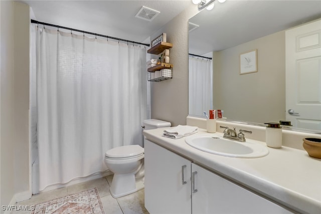 bathroom featuring toilet, vanity, tile patterned floors, and a shower with shower curtain