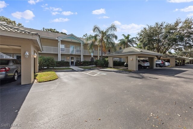 view of parking / parking lot featuring a carport