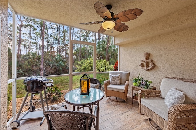 sunroom / solarium featuring ceiling fan