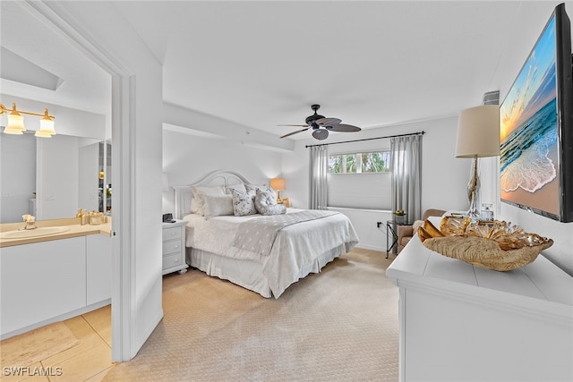 carpeted bedroom featuring sink and ceiling fan