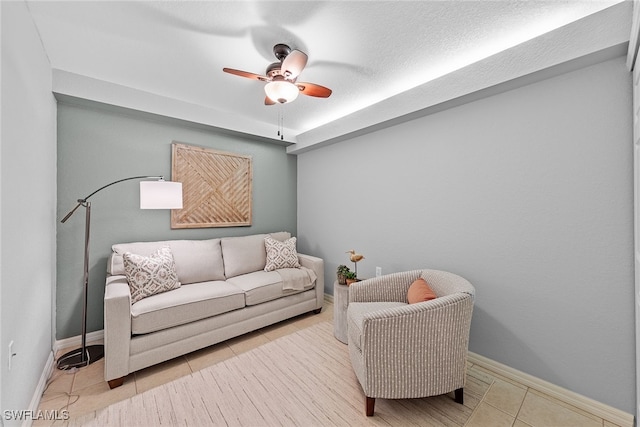 sitting room featuring ceiling fan, a textured ceiling, and light tile patterned floors