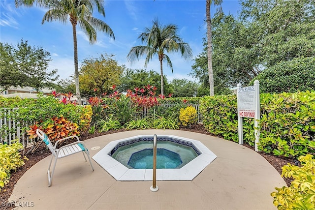 view of swimming pool with a community hot tub