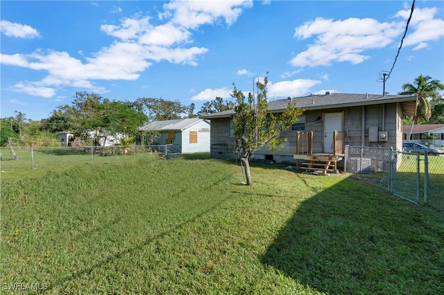 rear view of house featuring a yard