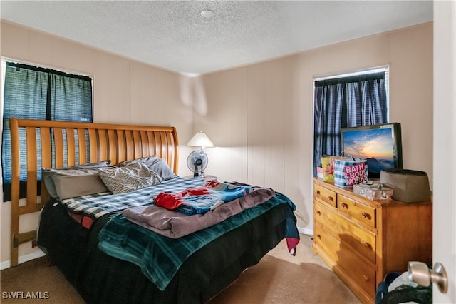 bedroom featuring a textured ceiling and carpet flooring