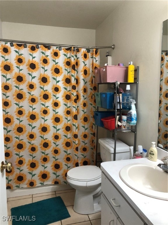 bathroom with vanity, a shower with curtain, toilet, and tile patterned floors