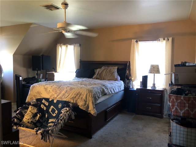 carpeted bedroom with vaulted ceiling and ceiling fan