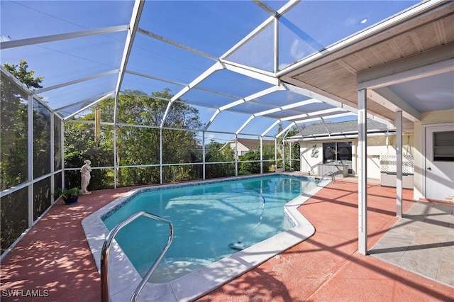 view of swimming pool featuring a patio and glass enclosure