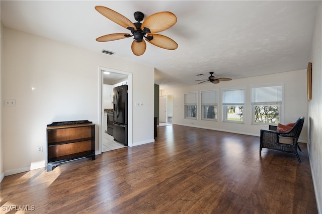 living room featuring ceiling fan and light wood-type flooring