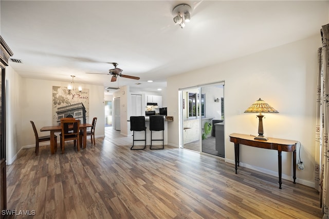 interior space featuring a fireplace, dark hardwood / wood-style floors, and ceiling fan