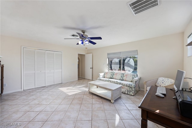 tiled living room with ceiling fan