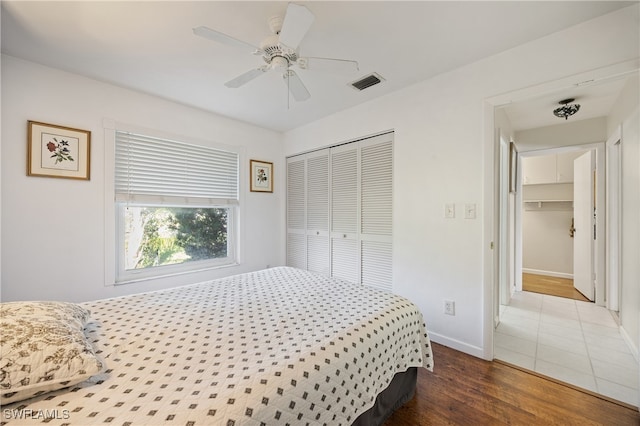 bedroom featuring a closet, ceiling fan, and wood-type flooring