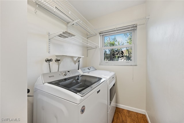 laundry room featuring washer and dryer and dark hardwood / wood-style floors