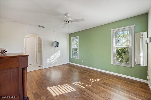 unfurnished room with ceiling fan and hardwood / wood-style floors