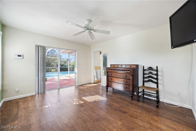 interior space featuring ceiling fan and dark hardwood / wood-style flooring