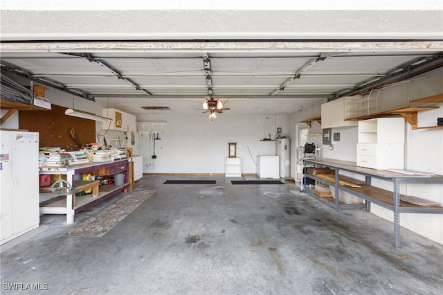 garage with a garage door opener, a workshop area, electric panel, and water heater