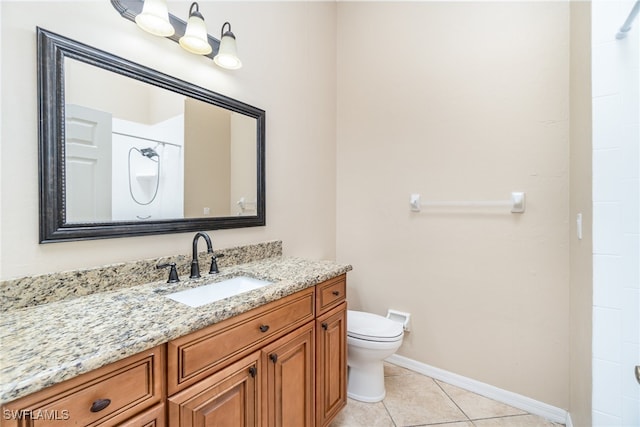 bathroom featuring vanity, toilet, and tile patterned flooring