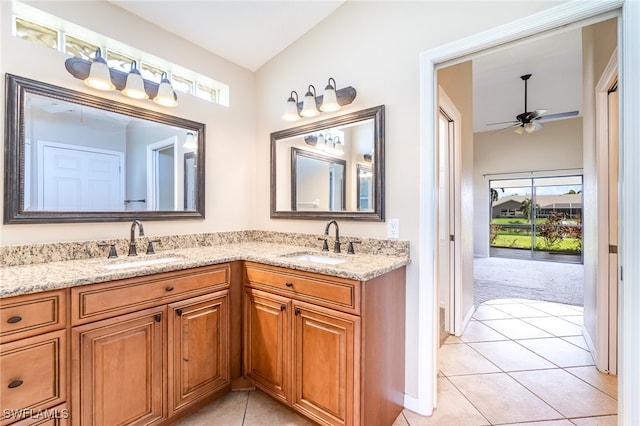 bathroom with vanity, ceiling fan, vaulted ceiling, and tile patterned flooring