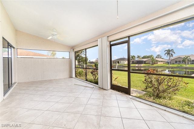 unfurnished sunroom featuring a water view, ceiling fan, and lofted ceiling