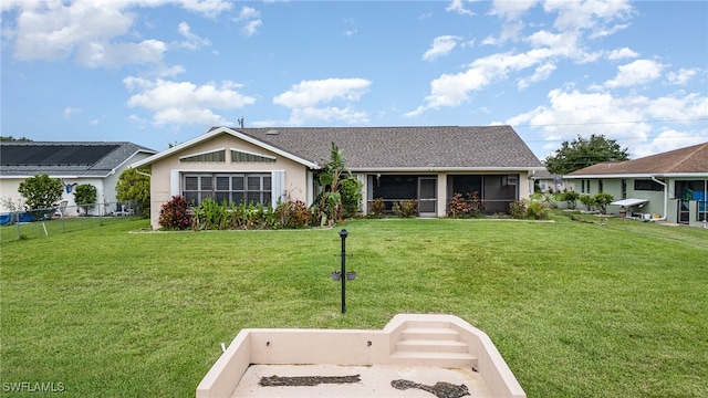 view of front of property featuring a sunroom and a front lawn