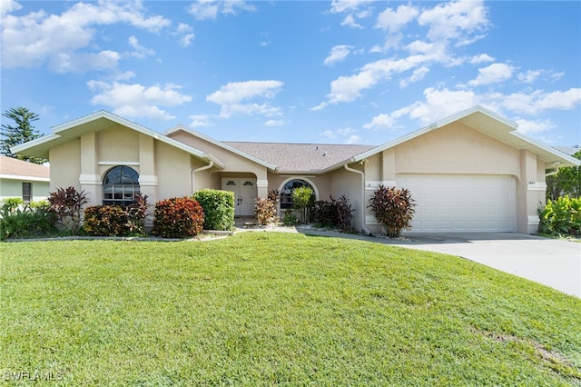 ranch-style home with a front yard and a garage