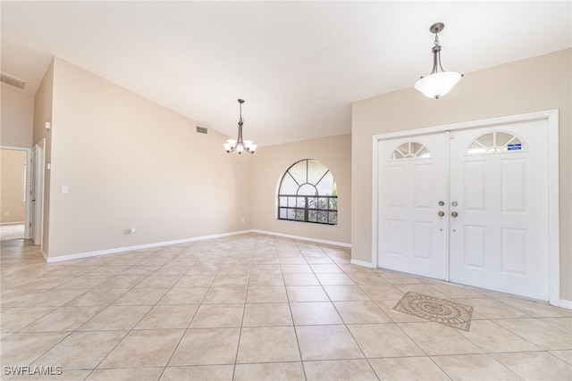 tiled entryway with an inviting chandelier