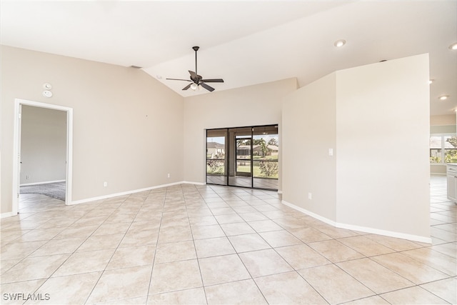 tiled empty room featuring lofted ceiling, a healthy amount of sunlight, and ceiling fan