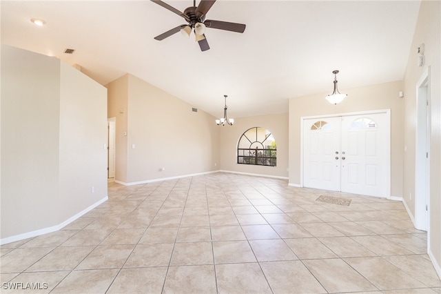 foyer entrance featuring vaulted ceiling, ceiling fan with notable chandelier, and light tile patterned floors