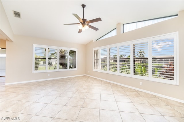 empty room featuring light tile patterned flooring, high vaulted ceiling, and ceiling fan