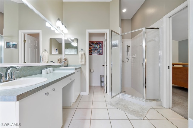 bathroom with vanity, a towering ceiling, a shower with shower door, and tile patterned flooring