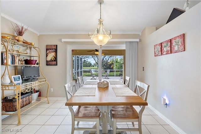 tiled dining space featuring ceiling fan and crown molding