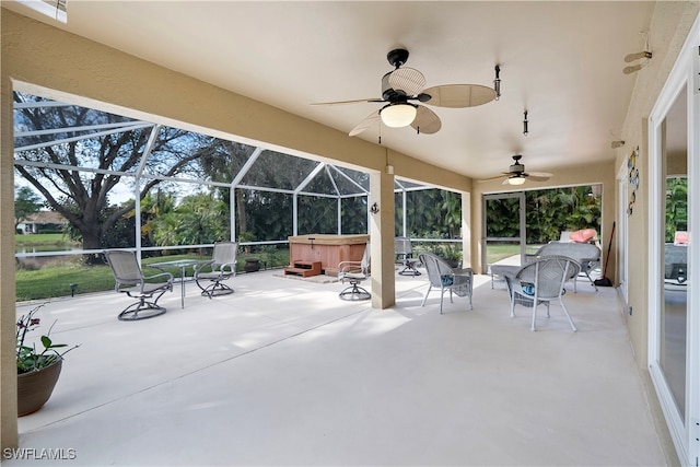 view of patio featuring a hot tub, a lanai, and ceiling fan