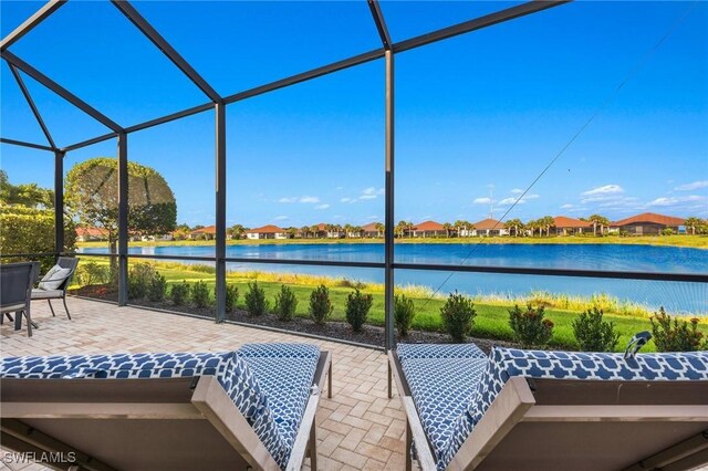 unfurnished sunroom with a water view