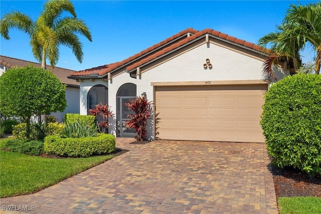 mediterranean / spanish-style home featuring a garage