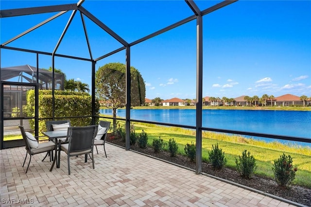 unfurnished sunroom featuring a water view