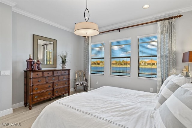 bedroom featuring light wood-type flooring and crown molding