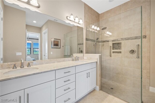 bathroom featuring an enclosed shower, vanity, and tile patterned floors