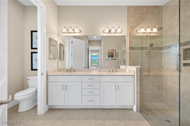 bathroom featuring toilet, vanity, and a shower with shower door