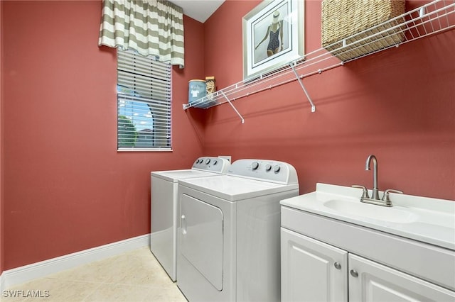 laundry area featuring cabinets, washing machine and clothes dryer, and sink